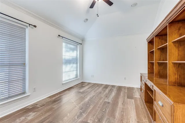 a view of a room with wooden floor and windows