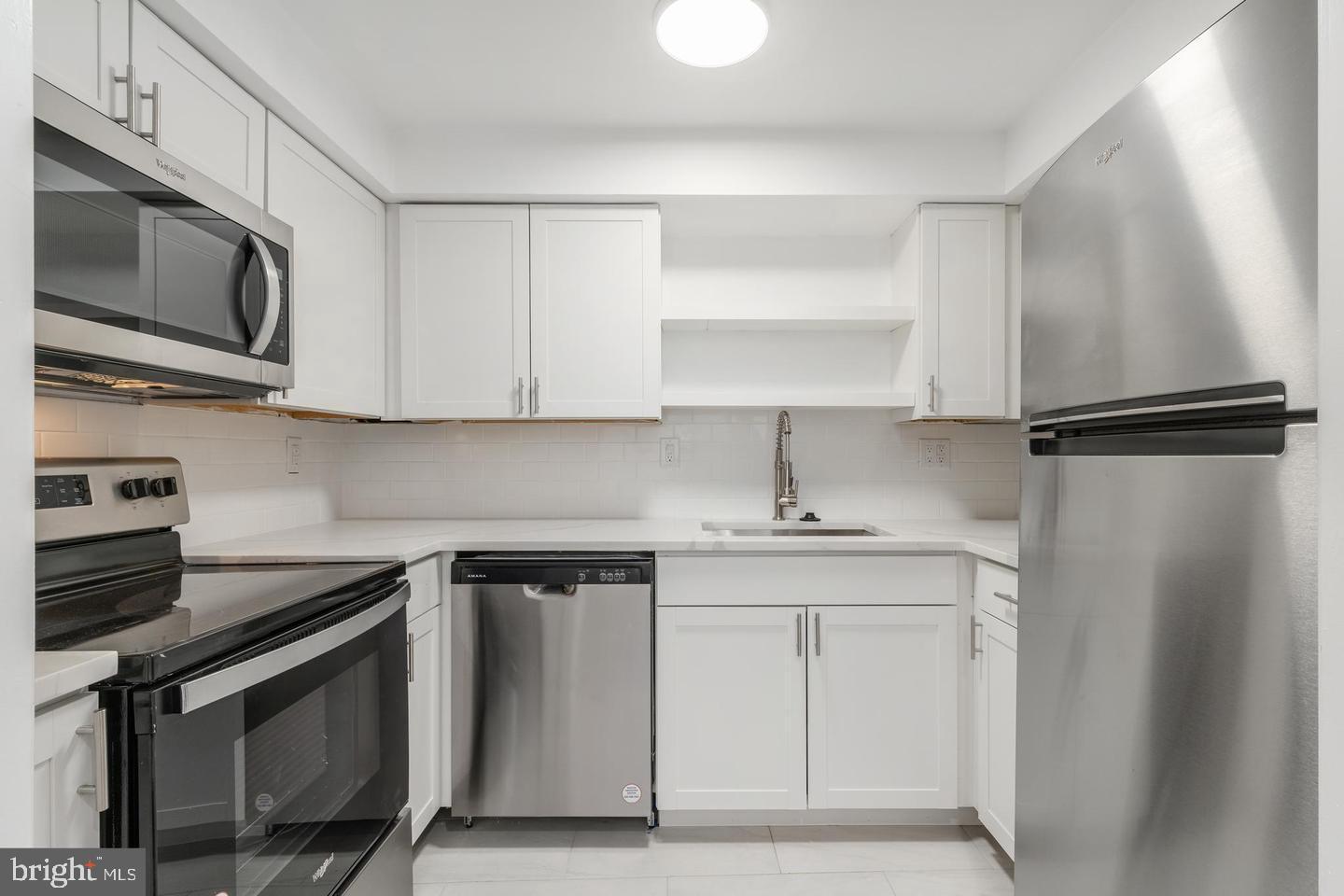 422 South 15th Street, Unit 1 Philadelphia, PA 19146 - Photo 13 of 19 a kitchen with stainless steel appliances a sink stove and refrigerator