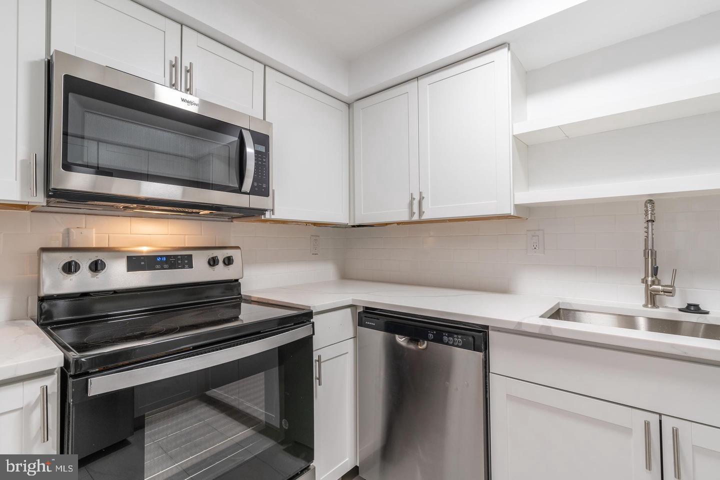 422 South 15th Street, Unit 1 Philadelphia, PA 19146 - Photo 14 of 19 a kitchen with a stove microwave and sink