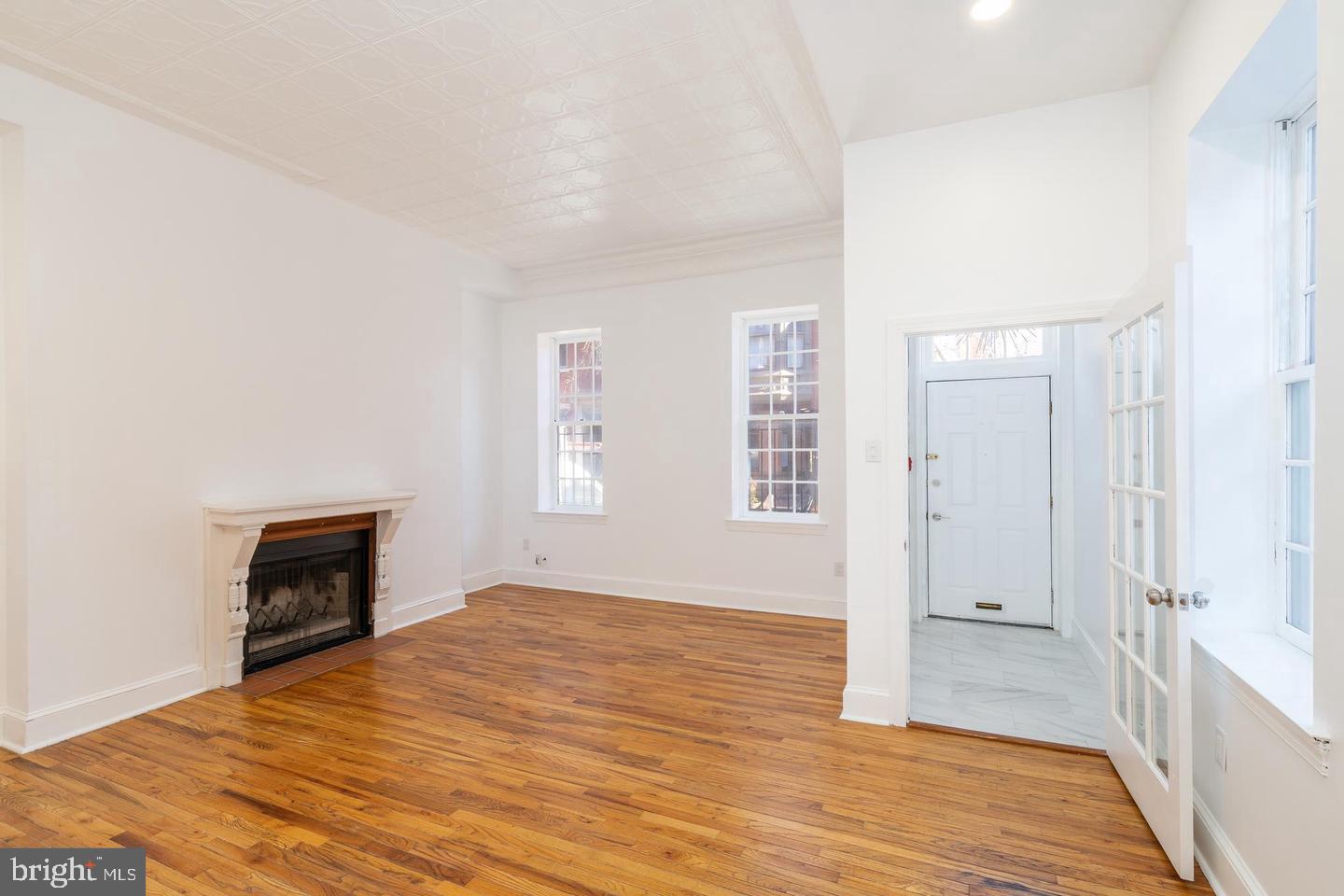 422 South 15th Street, Unit 1 Philadelphia, PA 19146 - Photo 4 of 19 an empty room with wooden floor and windows