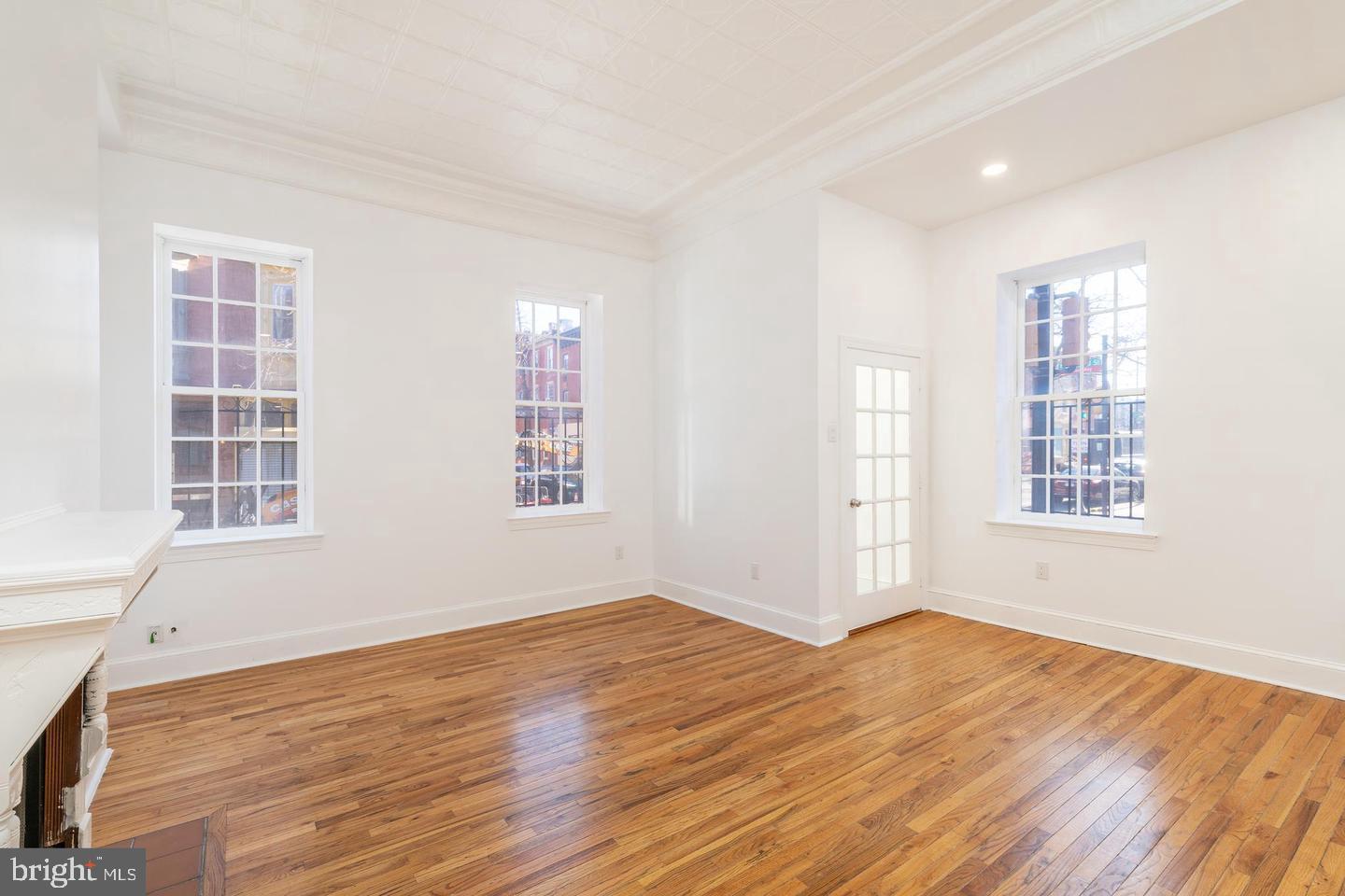 422 South 15th Street, Unit 1 Philadelphia, PA 19146 - Photo 5 of 19 an empty room with wooden floor and windows