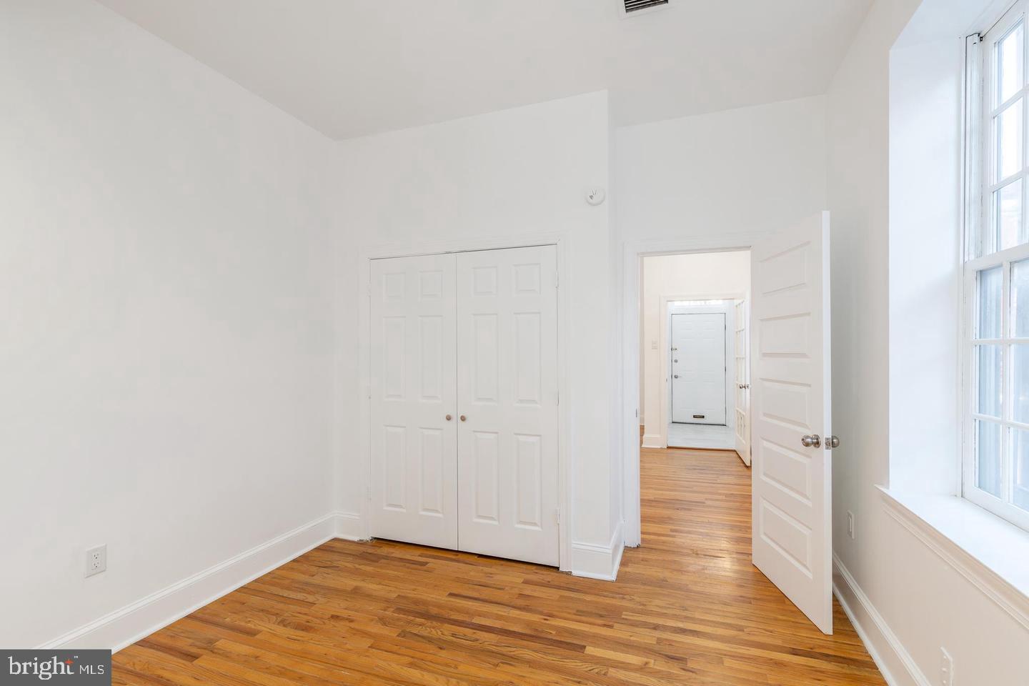 422 South 15th Street, Unit 1 Philadelphia, PA 19146 - Photo 8 of 19 a view of a room with wooden floor and white doors
