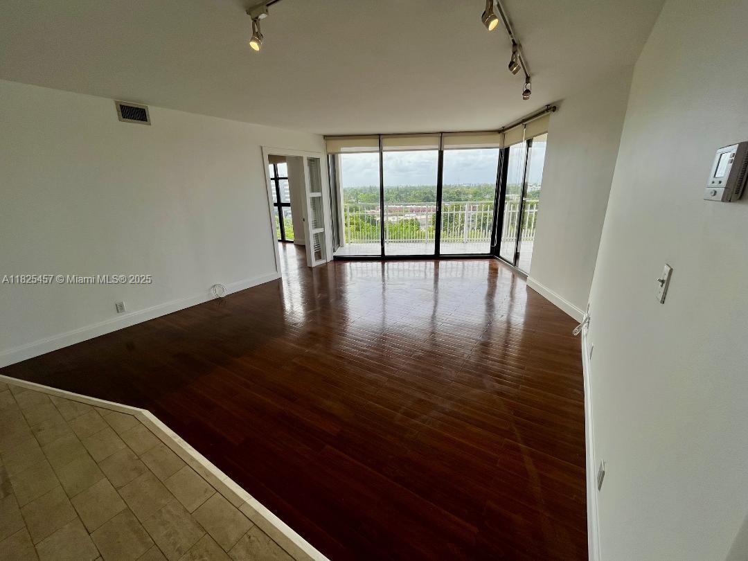 1000 Quayside Terrace, Unit 1009 Miami, FL 33138 - Photo 15 of 50 a view of an empty room with wooden floor and a window