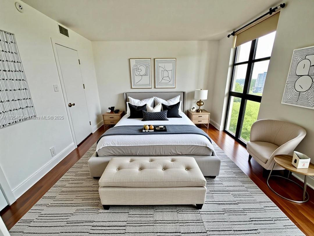1000 Quayside Terrace, Unit 1009 Miami, FL 33138 - Photo 16 of 50 a bed sitting in a bedroom next to a window with a rug and a wooden floor