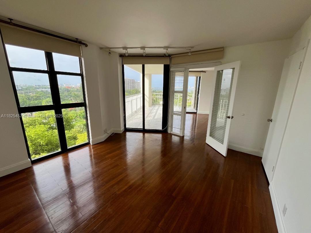 1000 Quayside Terrace, Unit 1009 Miami, FL 33138 - Photo 17 of 50 wooden floor in an empty room with a window