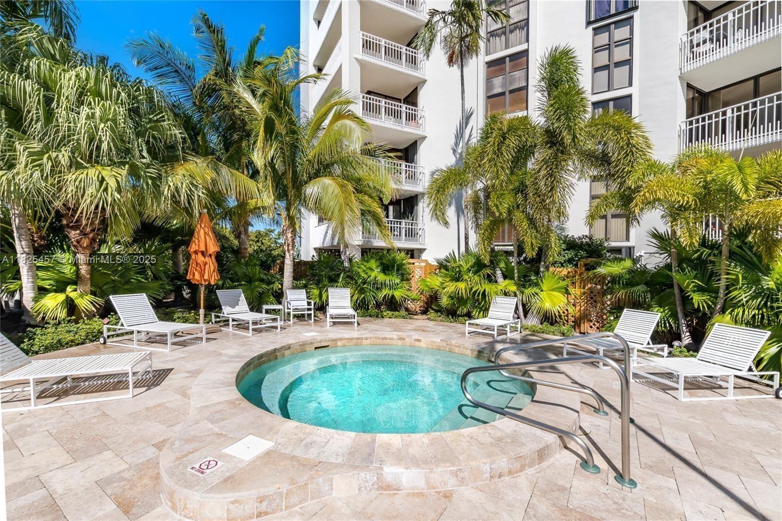 1000 Quayside Terrace, Unit 1009 Miami, FL 33138 - Photo 29 of 50 a view of a swimming pool with a lounge chairs