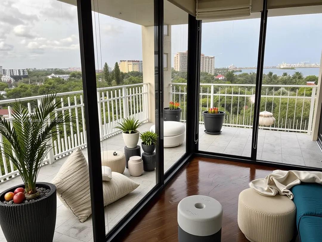 1000 Quayside Terrace, Unit 1009 Miami, FL 33138 - Photo 3 of 50 a living room with furniture and a potted plant