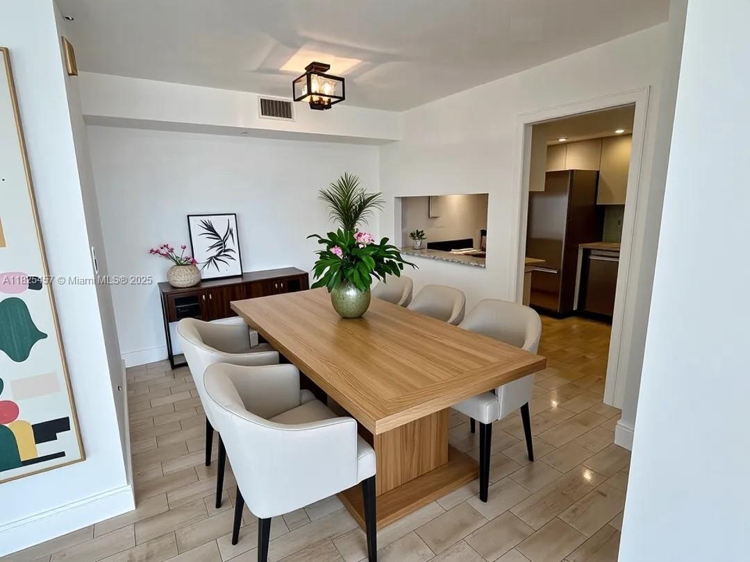 1000 Quayside Terrace, Unit 1009 Miami, FL 33138 - Photo 5 of 50 a dining room with furniture and wooden floor