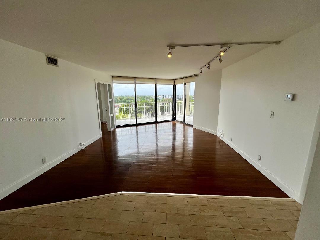 1000 Quayside Terrace, Unit 1009 Miami, FL 33138 - Photo 8 of 50 a view of an empty room with wooden floor and a window