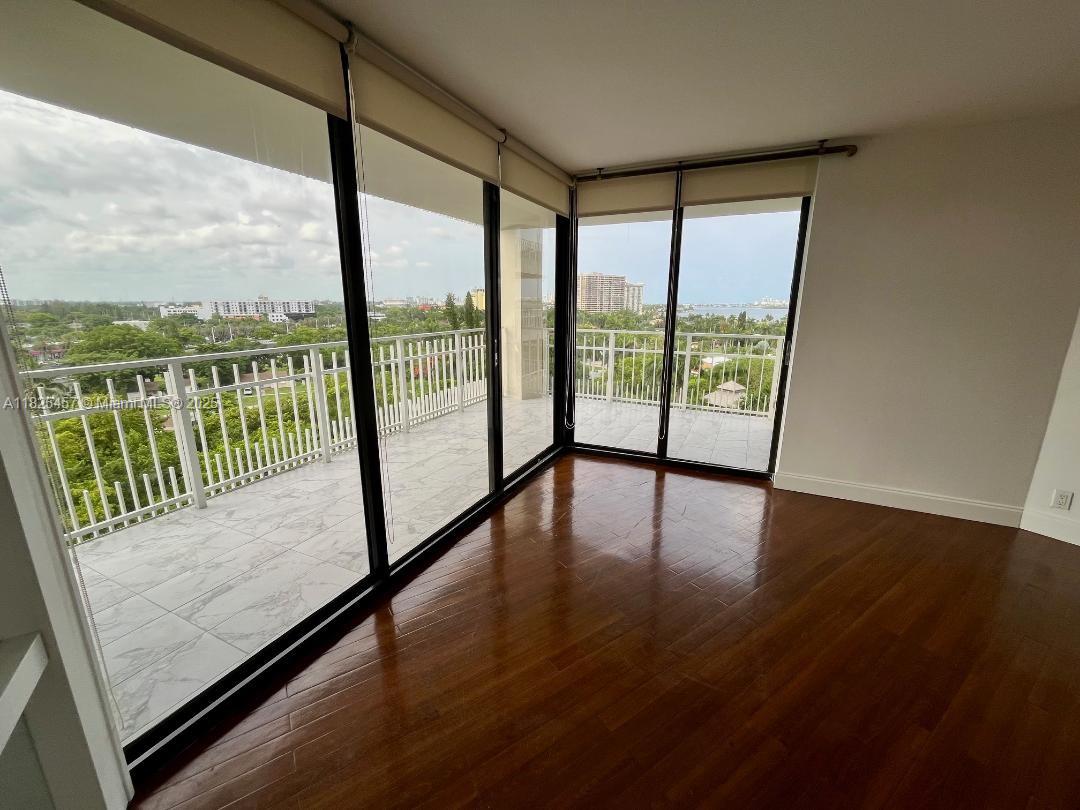 1000 Quayside Terrace, Unit 1009 Miami, FL 33138 - Photo 9 of 50 an empty room with wooden floor and windows