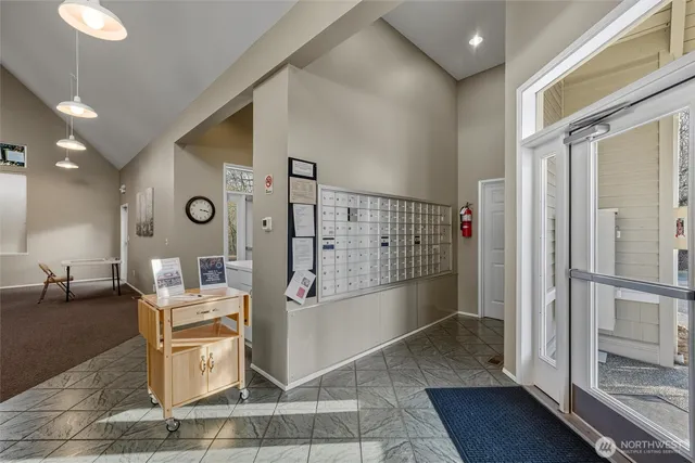 a living room with lots of furniture and a glass door shower