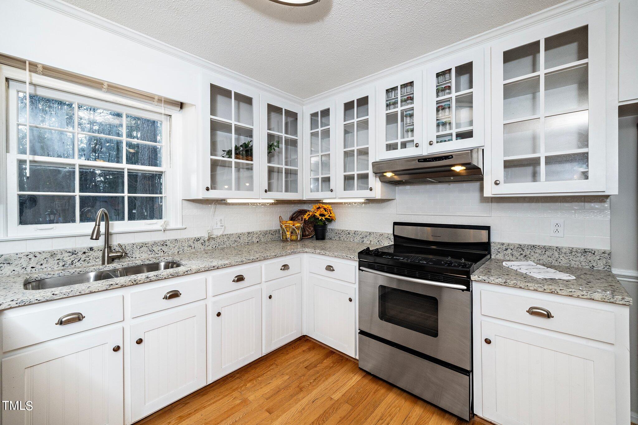 5705 Timber Ridge Drive Raleigh, NC 27609 - Photo 2 of 31 a kitchen with stainless steel appliances granite countertop a stove and cabinets