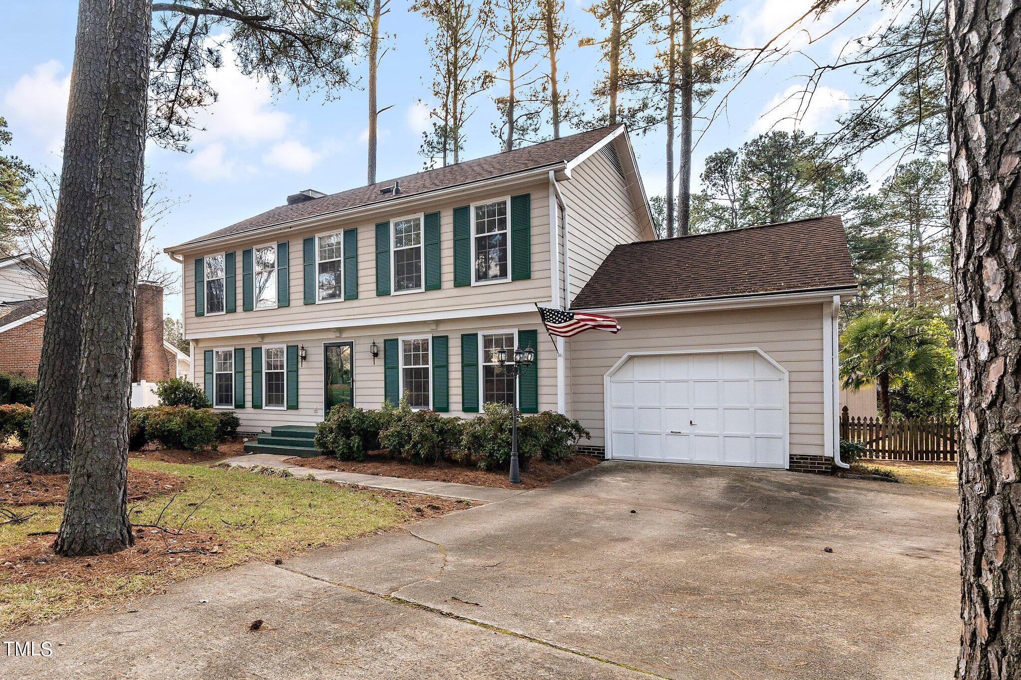 5705 Timber Ridge Drive Raleigh, NC 27609 - Photo 23 of 31 a front view of a house with a yard and garage