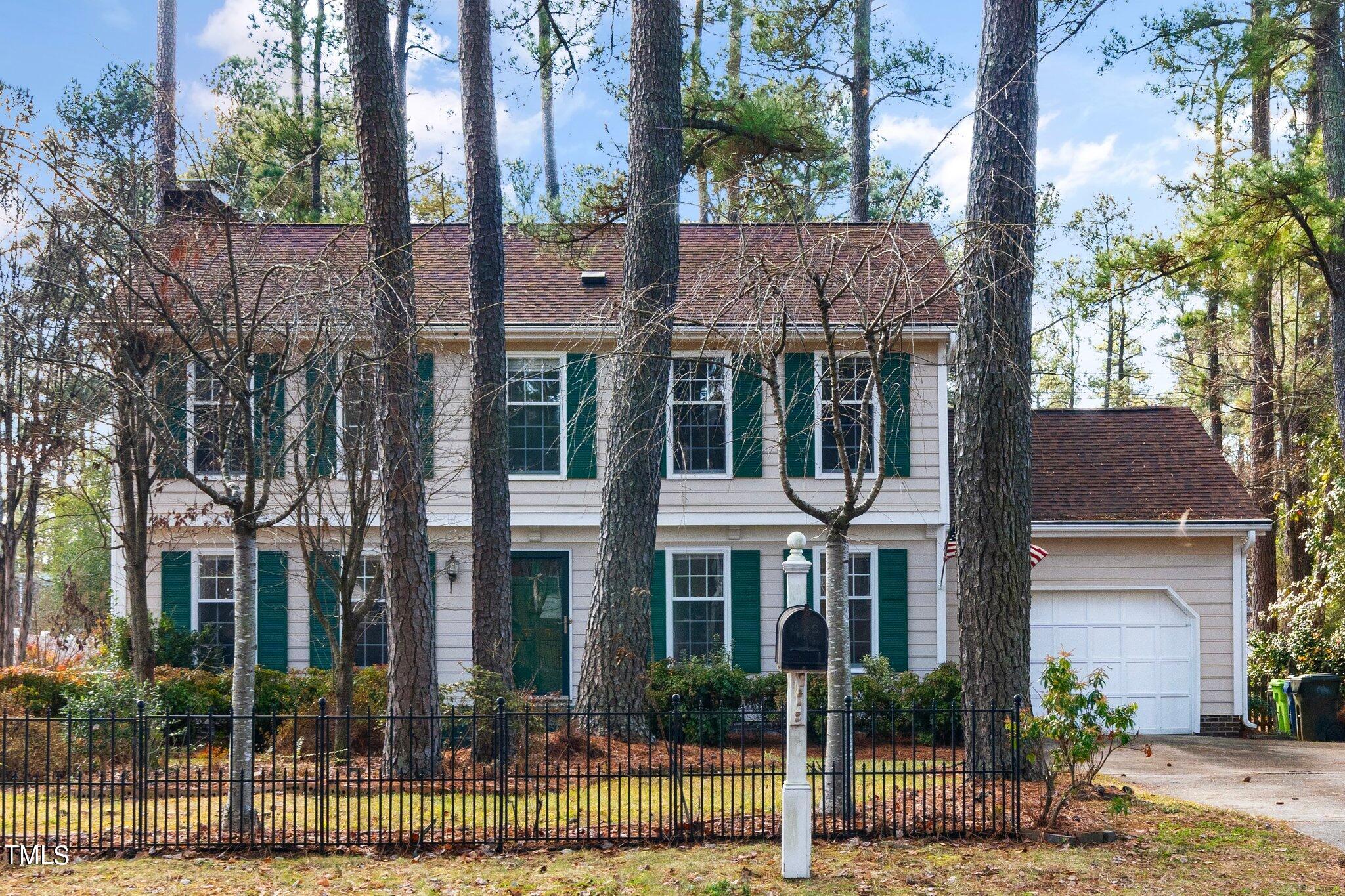 5705 Timber Ridge Drive Raleigh, NC 27609 - Photo 24 of 31 a view of a brick house with a yard and large tree
