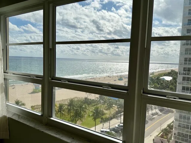 a view of a glass door with a from a glass window