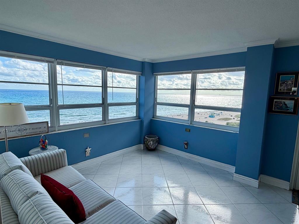 133 North Pompano Beach Boulevard, Unit 911 Pompano Beach, FL 33062 - Photo 4 of 21 a living room with furniture and a floor to ceiling window