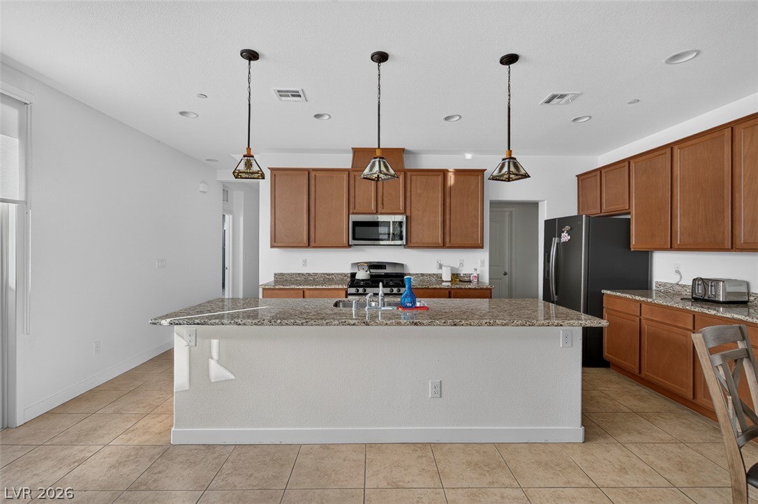 1100 East Sunset Road Henderson, NV 89011 - Photo 10 of 58 Culinary delights await in this modern kitchen with extensive counter space and ample storage.