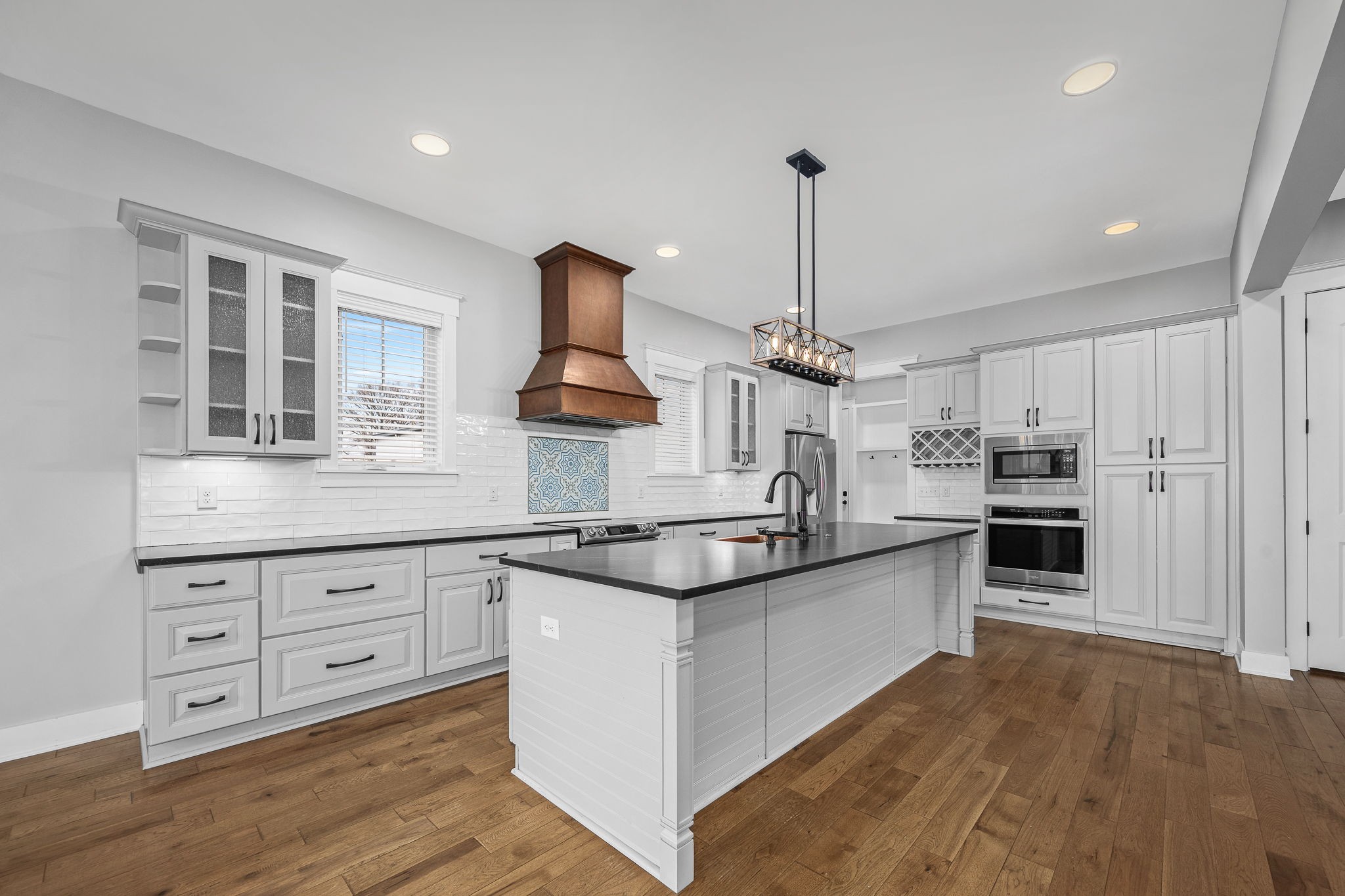 5296 Cross Plains Road White House, TN 37188 - Photo 15 of 87 a kitchen with stainless steel appliances granite countertop a sink a stove and a wooden floors