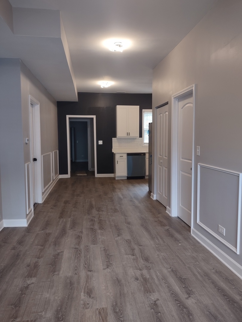 11531 South Perry Avenue Chicago, IL 60628 - Photo 14 of 16 an empty room with windows and cabinet