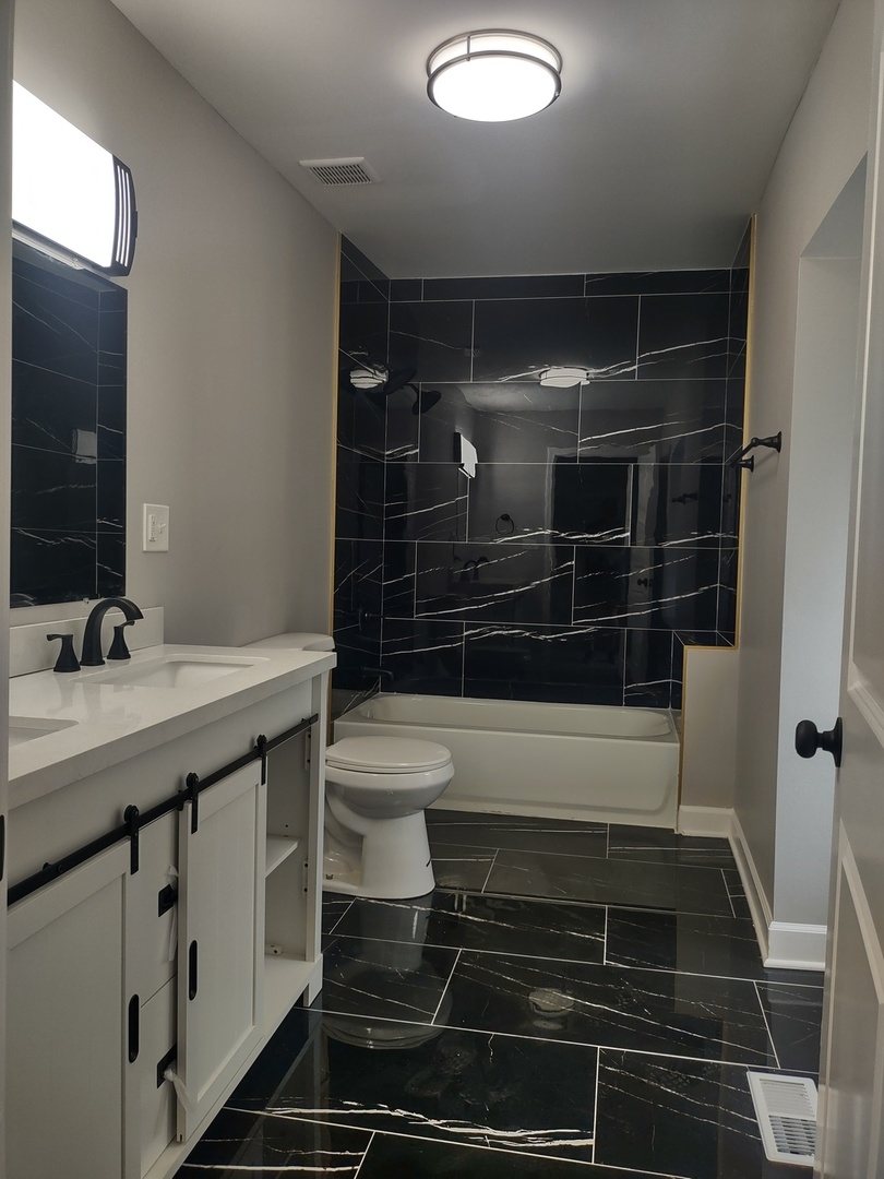 11531 South Perry Avenue Chicago, IL 60628 - Photo 6 of 16 a bathroom with a sink toilet and shower