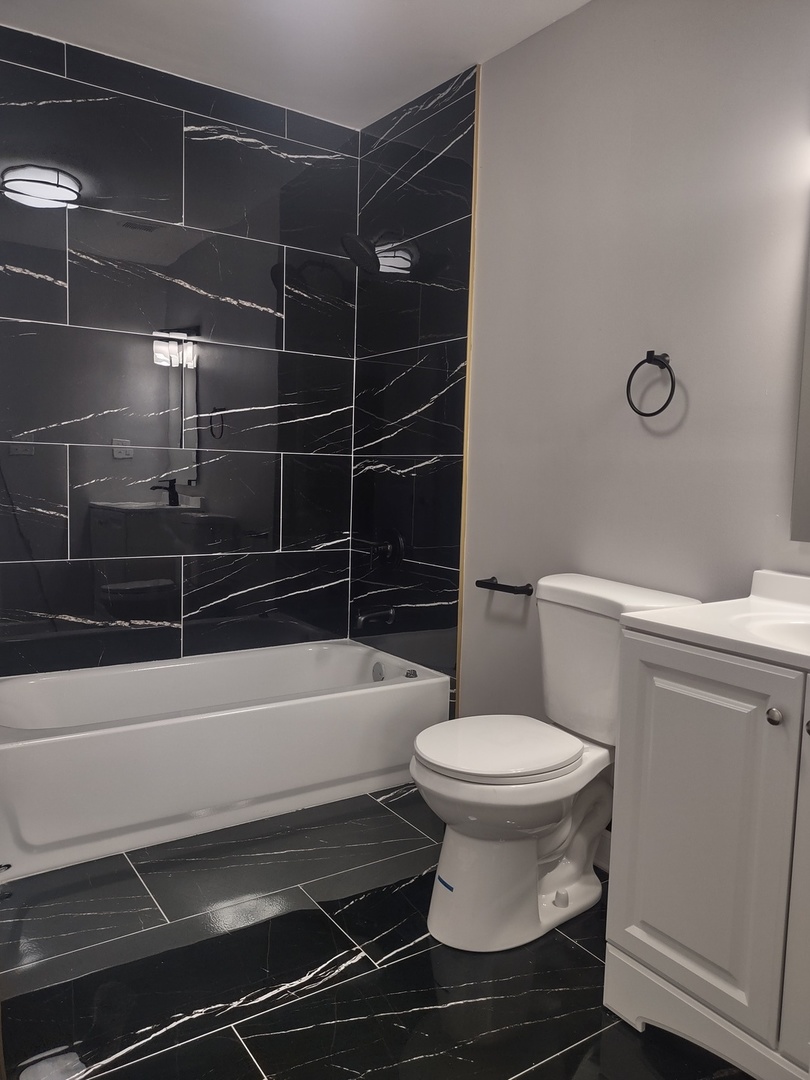 11531 South Perry Avenue Chicago, IL 60628 - Photo 7 of 16 a bathroom with a toilet and a shower