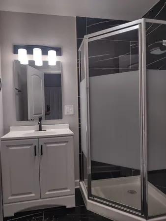 a bathroom with a mirror and a shower