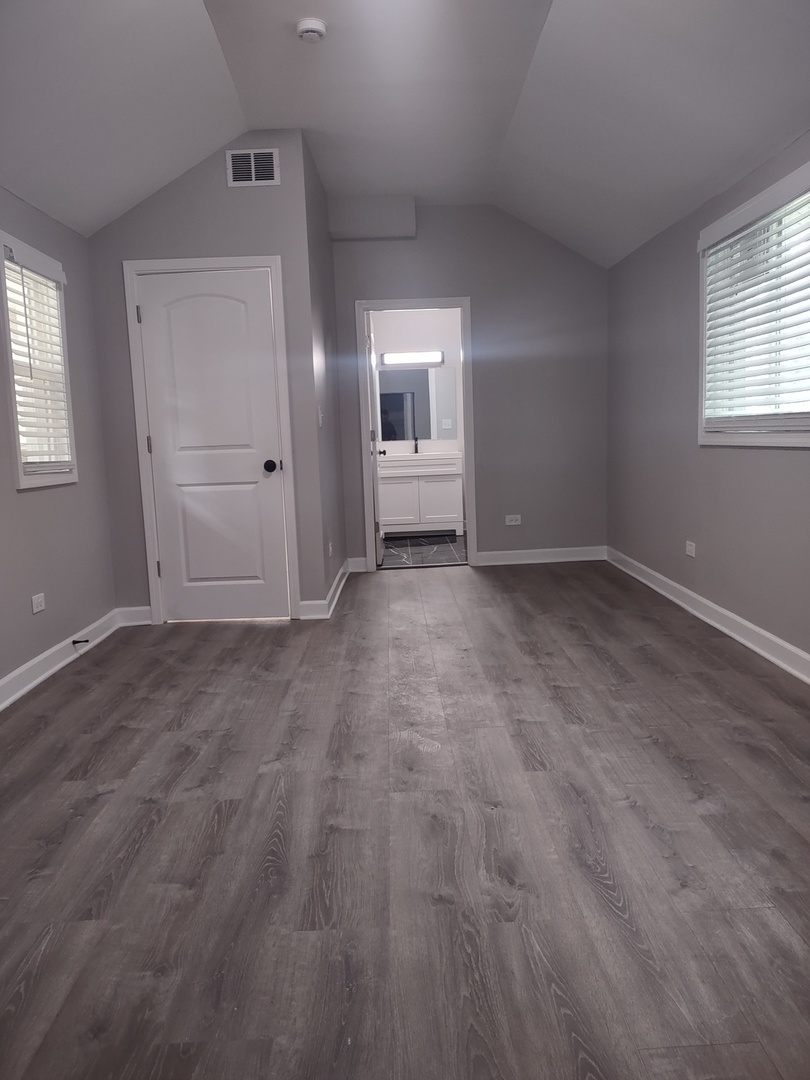 11531 South Perry Avenue Chicago, IL 60628 - Photo 10 of 16 an empty room with windows and closet