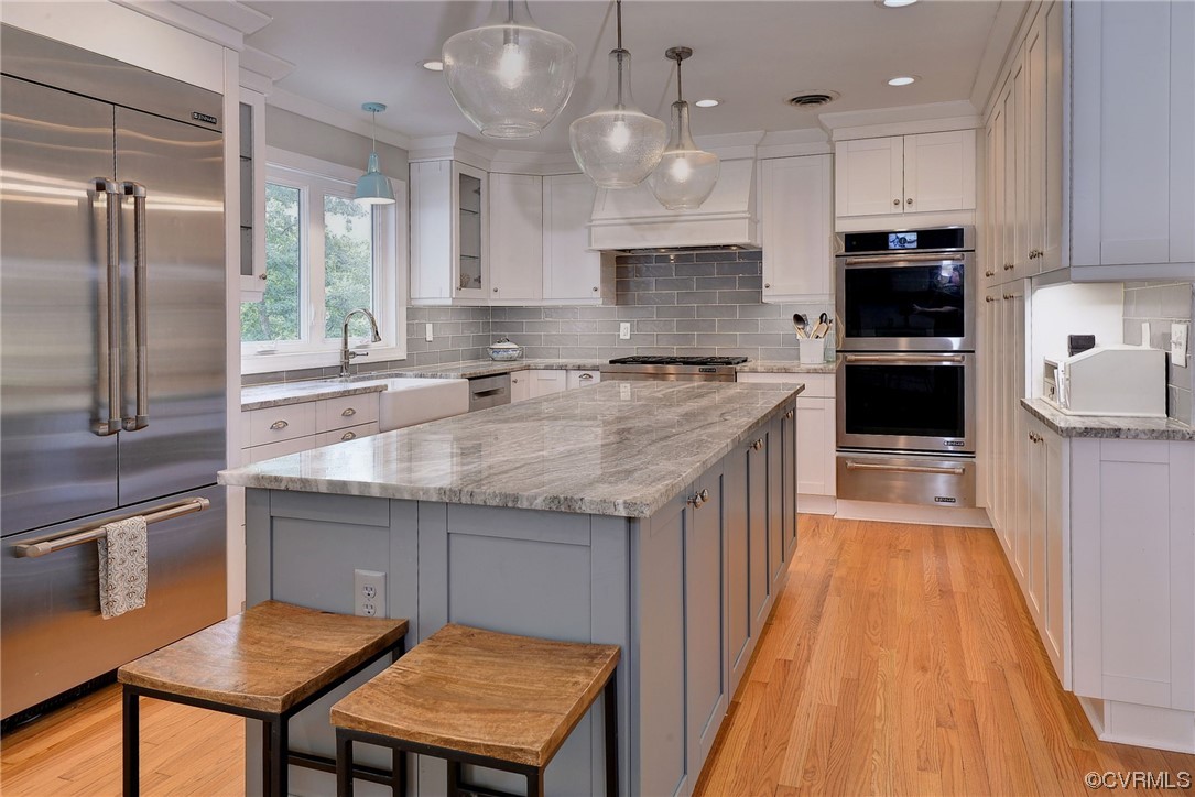 104 Lawnes Circle Williamsburg, VA 23185 - Photo 11 of 49 a kitchen with kitchen island a counter space a sink appliances and cabinets
