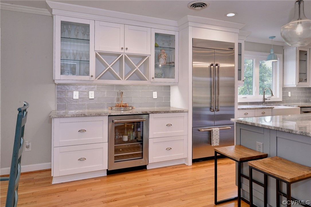 104 Lawnes Circle Williamsburg, VA 23185 - Photo 15 of 49 a kitchen with stainless steel appliances a stove a refrigerator and wooden cabinets