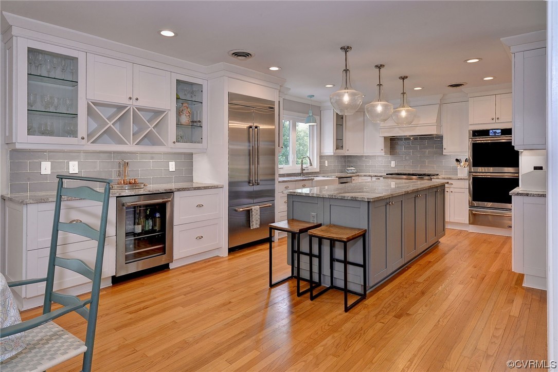 104 Lawnes Circle Williamsburg, VA 23185 - Photo 10 of 49 a kitchen with stainless steel appliances granite countertop a stove a sink dishwasher and a refrigerator with wooden floor