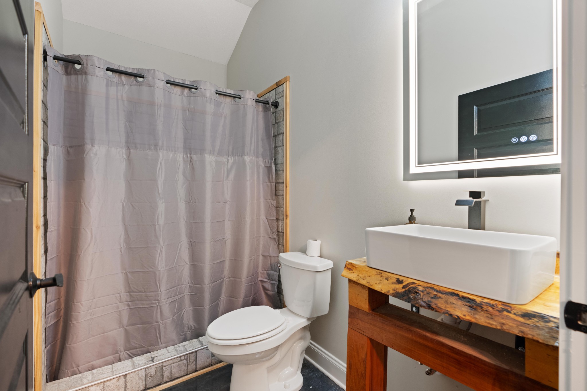 3320 Slayden-Marion Road Cumberland Furnace, TN 37051 - Photo 28 of 43 a bathroom with a sink toilet a mirror and shower curtain