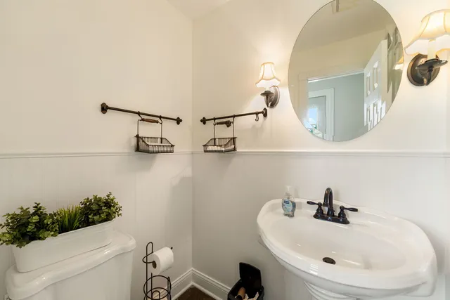 a bathroom with a sink a mirror and toilet