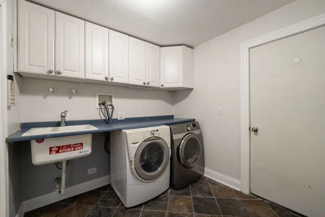 a utility room with sink dryer and washer