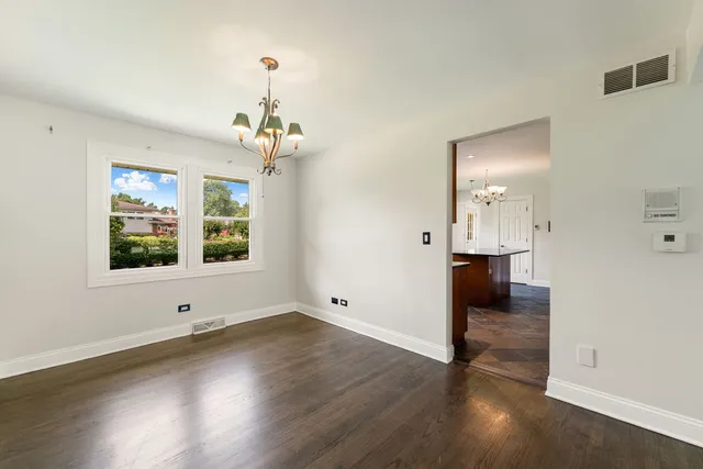 a view of a room with wooden floor and window