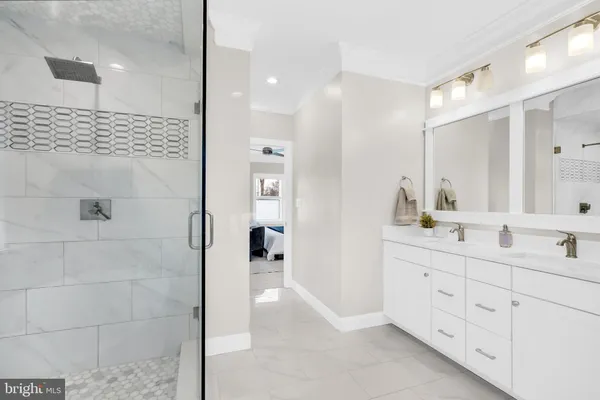 a white bath tub sitting next to a shower