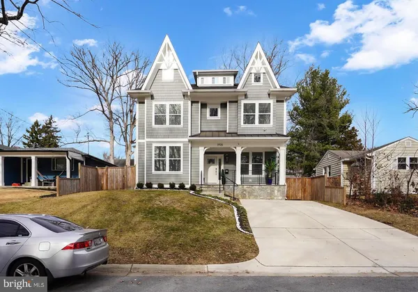 a front view of a house with a tree