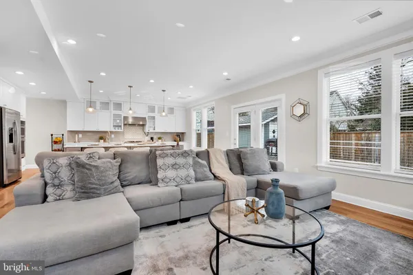 a living room kitchen with furniture and a large window