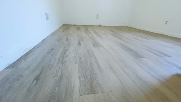 a view of a room with wooden floor