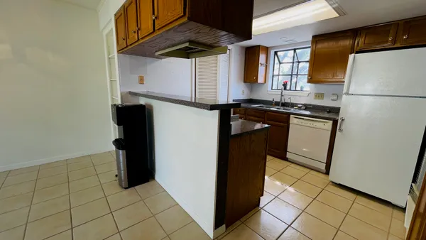 a kitchen with stainless steel appliances granite countertop a refrigerator and a stove