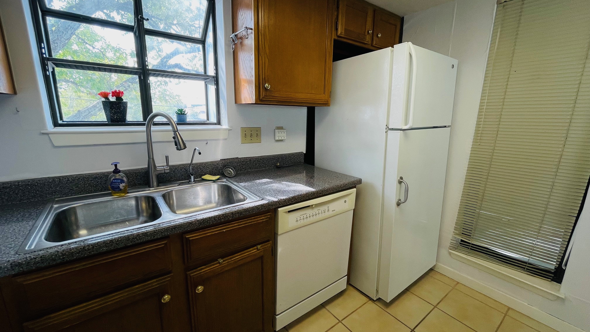 1510 West N Loop Boulevard, Unit 822 Austin, TX 78756 - Photo 3 of 12 a kitchen with a sink a refrigerator and a window