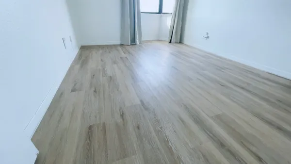 a view of a room with wooden floor
