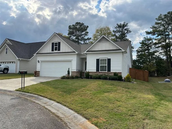 a view of a house with a yard and garage