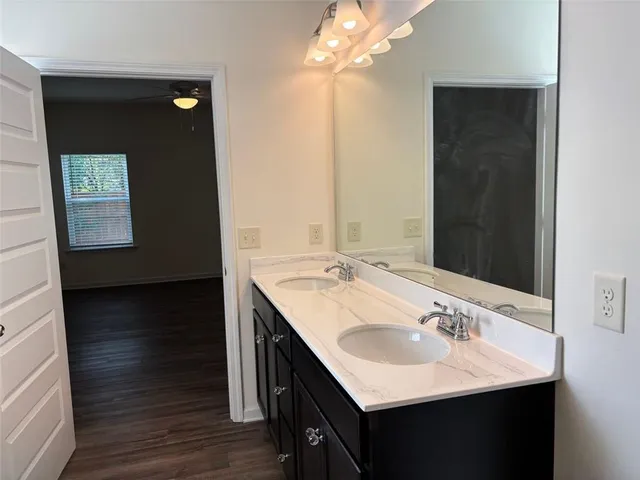 a kitchen with a sink and wooden floor