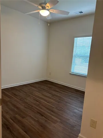 a view of walk in closet with wooden floor