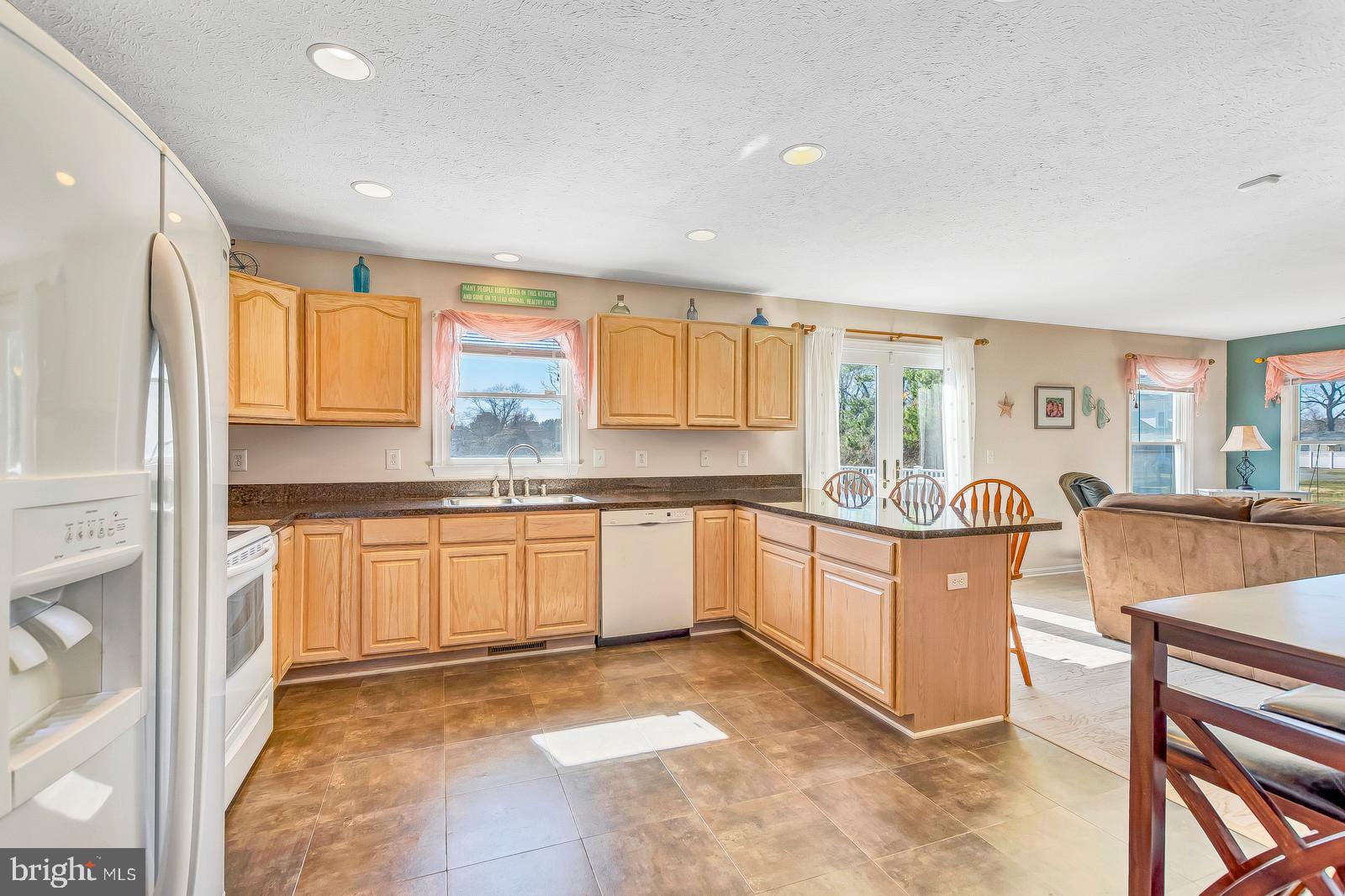 48948 Packer Court St. Inigoes, MD 20684 - Photo 9 of 45 a large kitchen with granite countertop a sink and cabinets