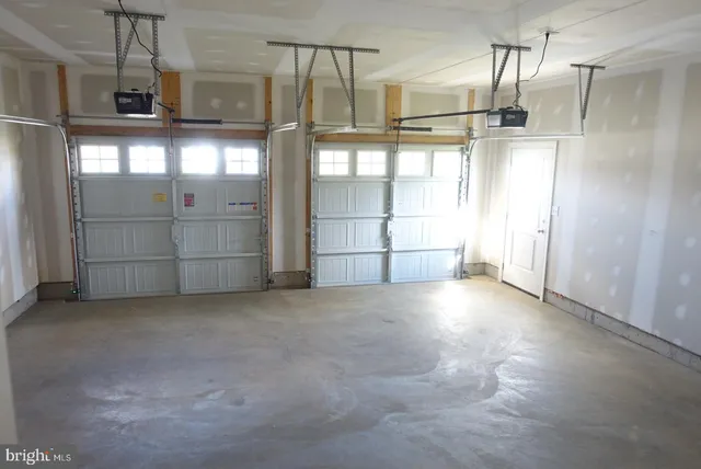 a view of staircase with lots of frames on wall and wooden floor