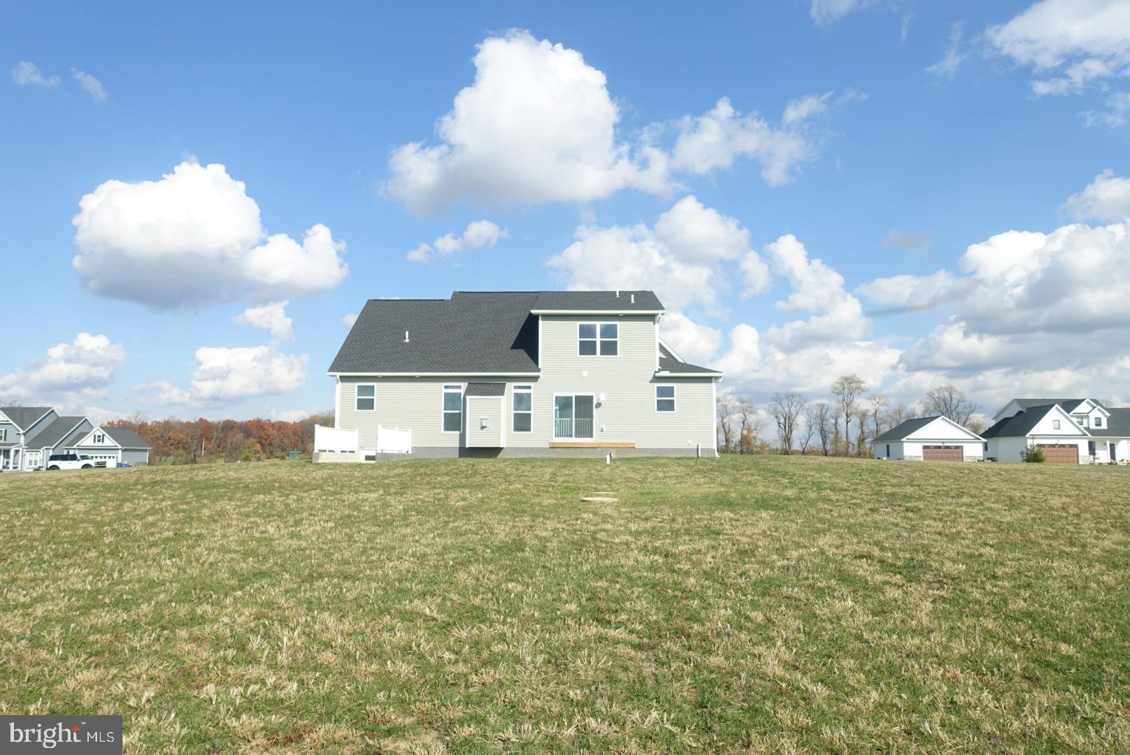 347 Steeple View Drive, Unit 11 Hanover, PA 17331 - Photo 46 of 47 a view of a big house with a big yard and a large tree