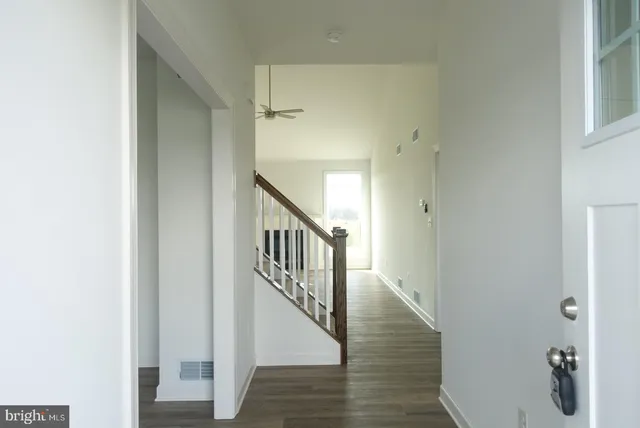 a view of an entryway with wooden floor
