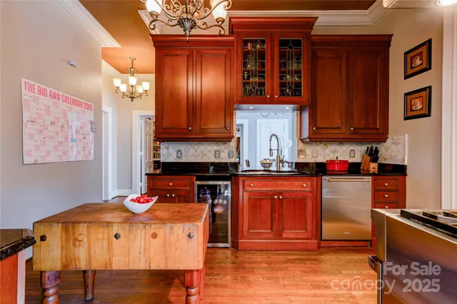 a kitchen with stainless steel appliances granite countertop a refrigerator and stove top oven