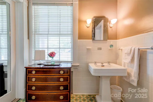 a living room with furniture a fireplace and a chandelier